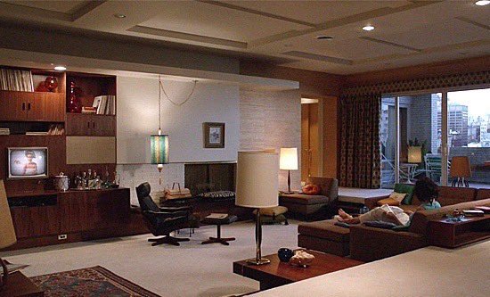 A warm, low-lit lounge of dark wood and shaded lamps