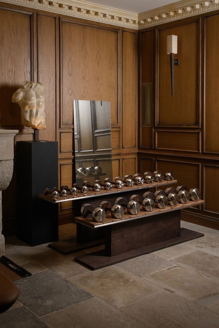A wood-panelled room with a stone bench and a classical bust